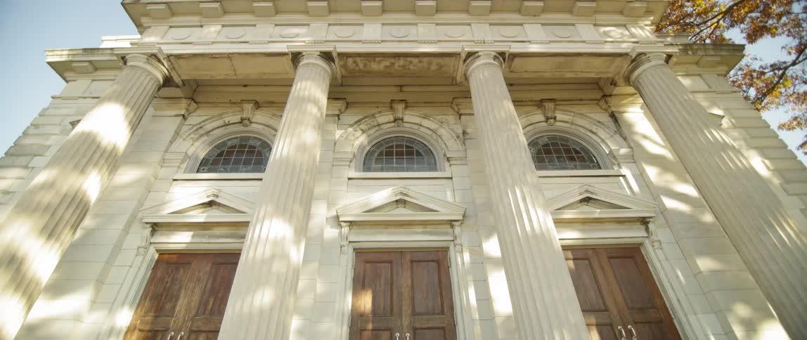 View of a large buildings with three doors in front