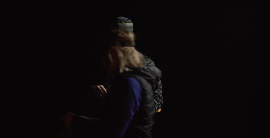 Couple using their headlamps  to perform their duties outdoors at night