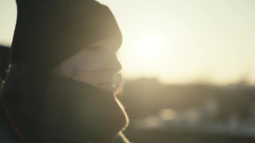 The sun shines down on a woman