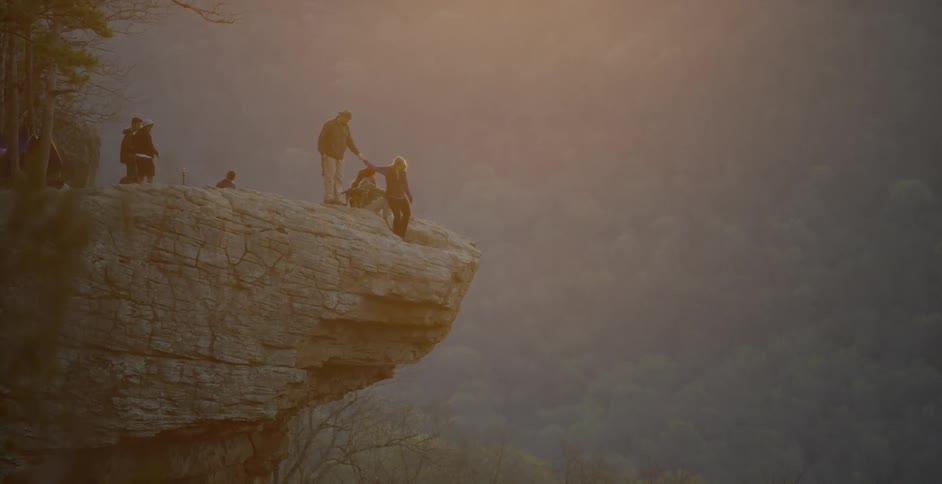 A group of people gather on a rocky overlook