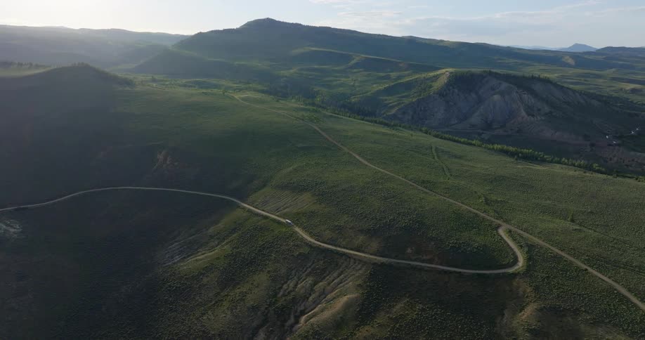 Aerial panorama of mountain ranges with narrow highways