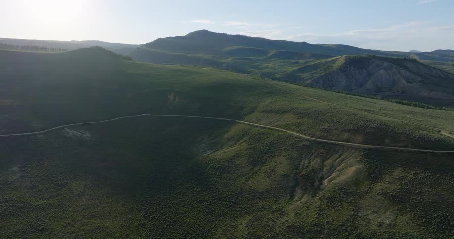 Aerial view of a mountain valley and a winding highway