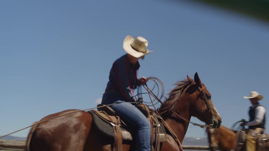 People on horseback inside a fence