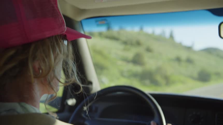A woman driving on a rural road