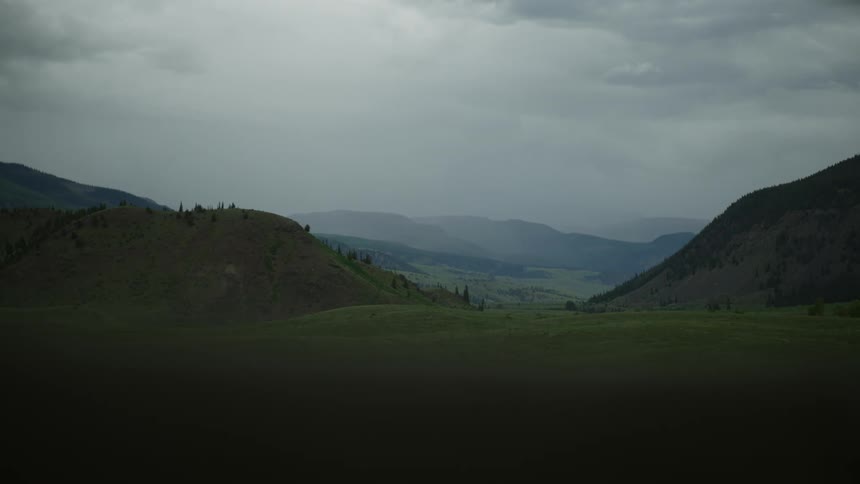 Landscape on a foggy day of a lush green mountain valley