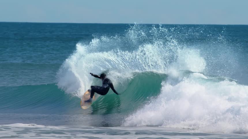 Surfer doing a ledge maneuver on a wave in the ocean