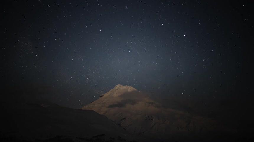A night clip of the sky and an ice mountain peak