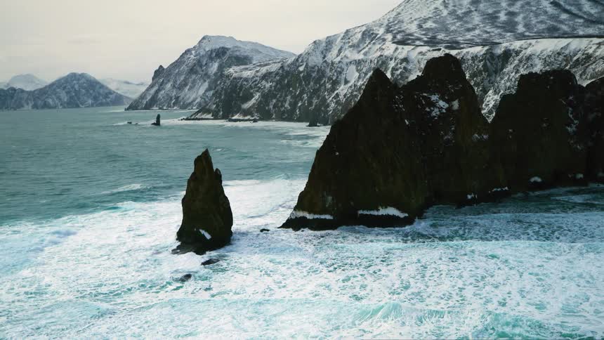 Aerial panorama with snowcovered rocky crust on the seashore