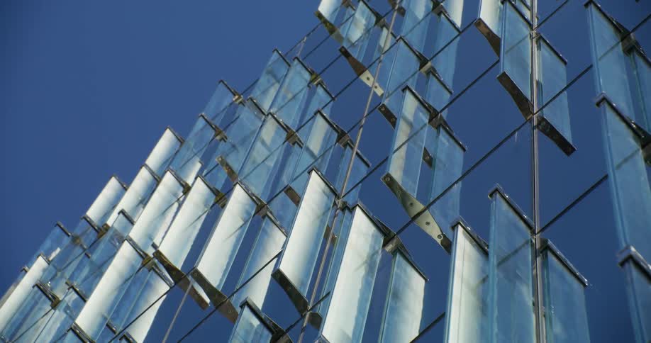 Numerous panels hanging from metal rods reach high into the air