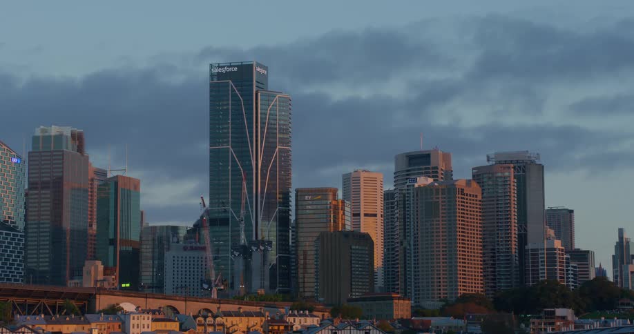 Salesforce building in city skyline on cloudy day