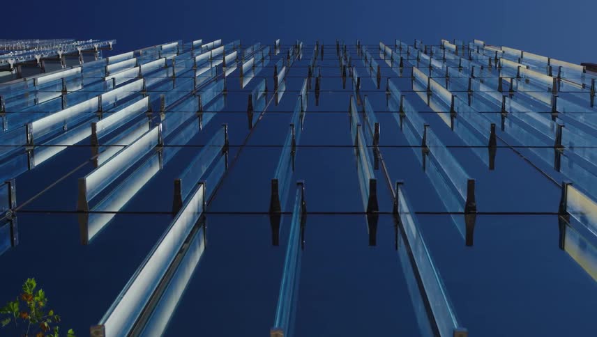Panels of glass suspended from bars stretching up into the sky