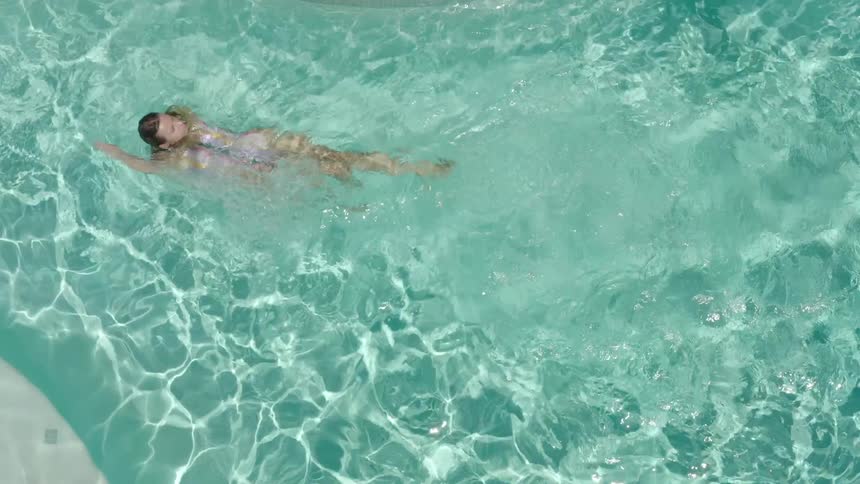 A girl swims in a pool