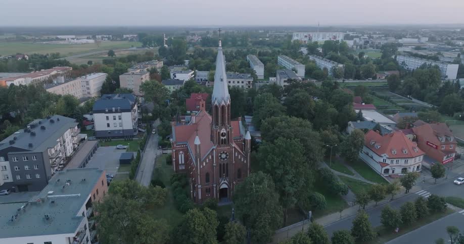Aerial view of a church with a large tower in an urban city