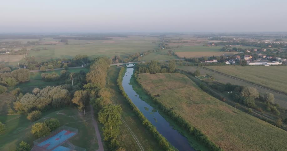 Aerial panorama of a river to a shepherd with a city in the background