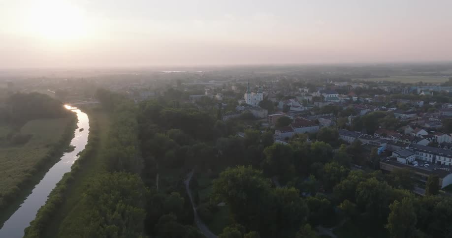 An aerial view of a small city in the early morning light