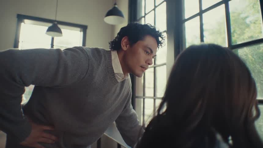 A man is nodding as he listens to a friend