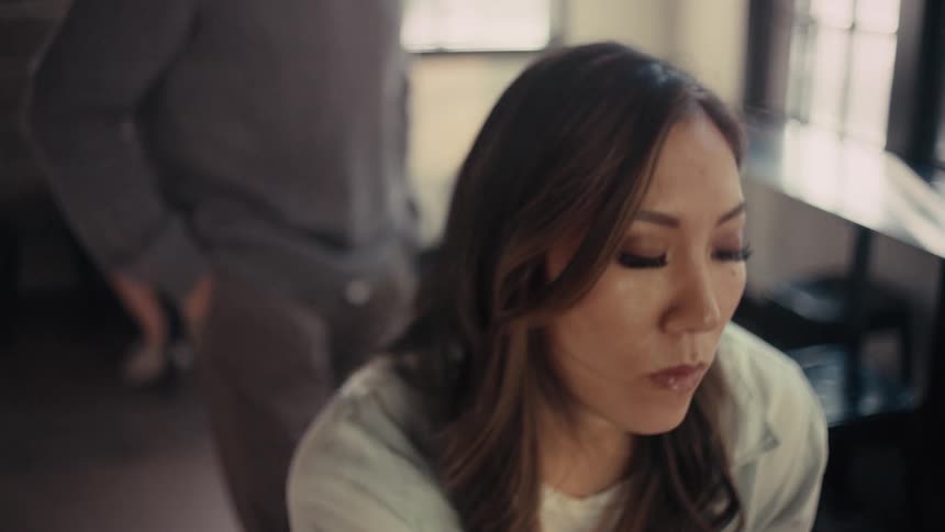 A clip of a lady thinking in the office