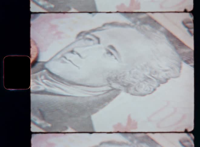 Closeup of a penny and paper money including a ten dollar bill