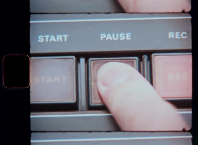 A person presses buttons on the recorder