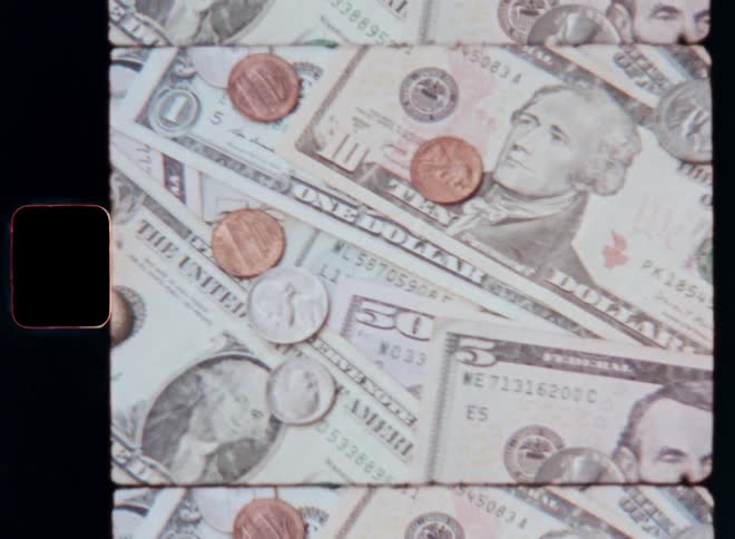 Close up of scattered coins and dollar bills