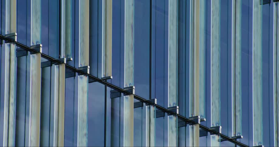 The side of a tall building covered in large glass only windows