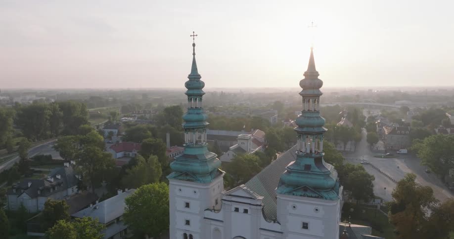 Aerial view of a church with two towers in the middle of a residential neighborhood