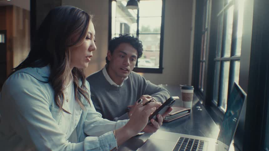 Man and woman sitting in an office room talking to each other