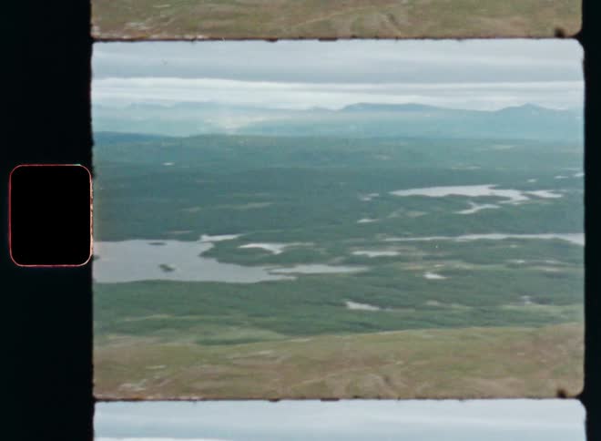 A landscape of a region with a river passing through a green region of vegetation