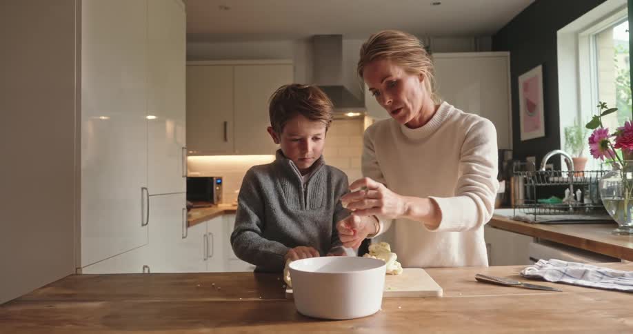 Mother and son in the kitchen cooking together