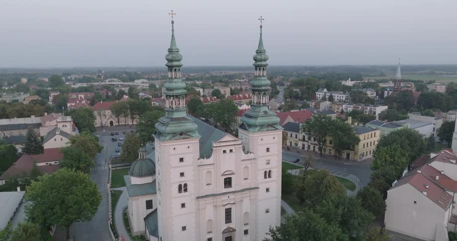 Landmark cathedral towers over nearby buildings under an overcast sky