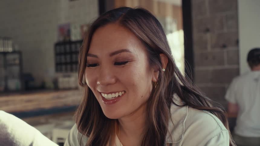 A woman smiles and talks with a friend