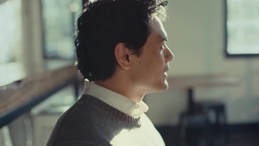Man sitting talking and nodding his head in a positive sign
