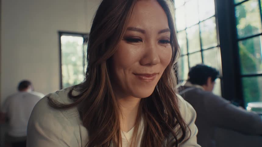 Woman with happy facial expression while sitting in an office environment
