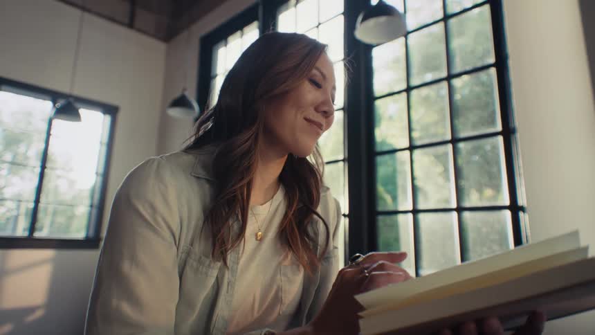 Woman sitting reading a book and thinking