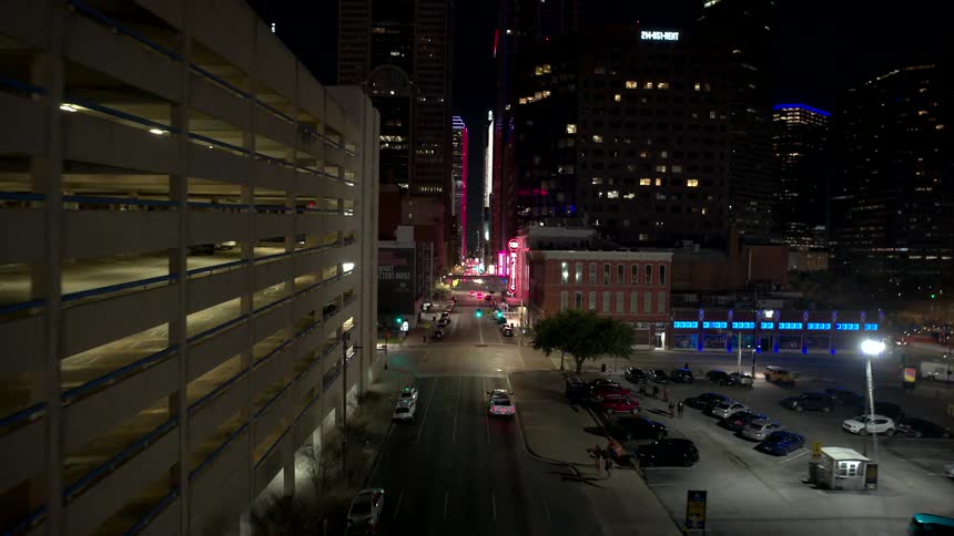 Aerial view of a metropolis with large buildings illuminated at night