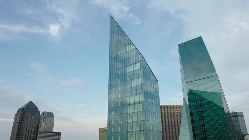 Aerial view of a modern mirrored building in a metropolis