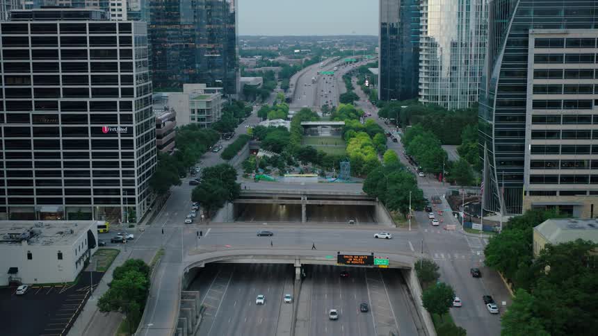 Cars drive along city streets