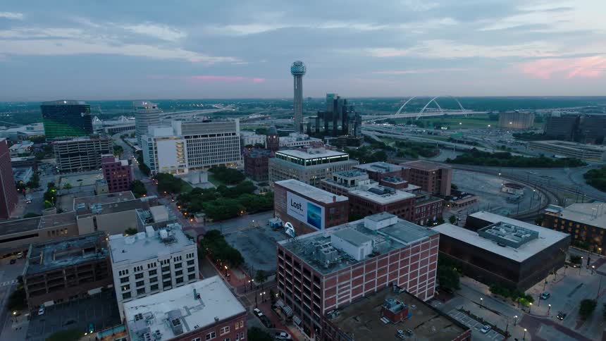 Aerial view of an urban city with a tower in the background