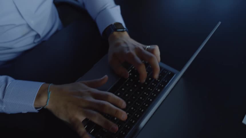People's hands at table typing their laptops