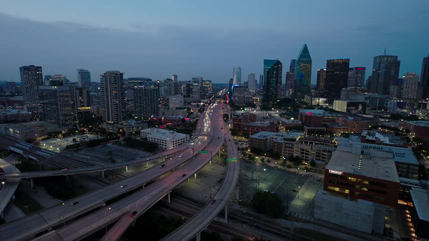 Aerial view of a highway and intersections in a metropolis with skyscrapers