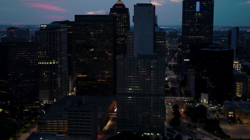 Aerial panorama of skyscrapers and intersections seen at night from a metropolis