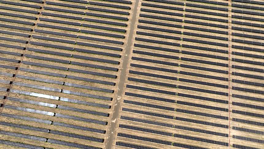 A large array of solar panels installed closely together covering an extensive area