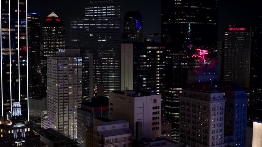 Aerial panorama of illuminated buildings and skyscrapers at night