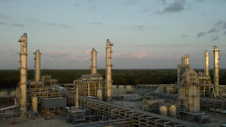 Aerial view of a refinery in a space surrounded by vegetation