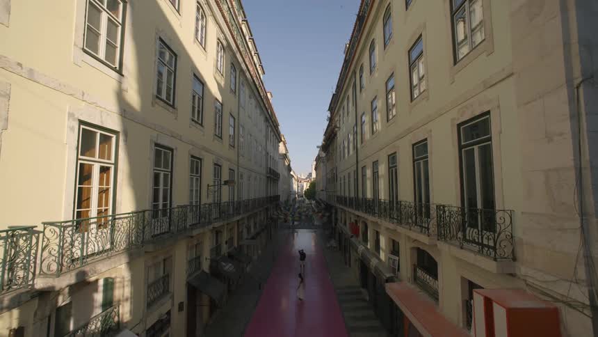 Narrow corridor between classical and urban buildings in a city