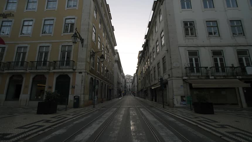 Quiet empty street flanked by multistory buildings with classic european architecture
