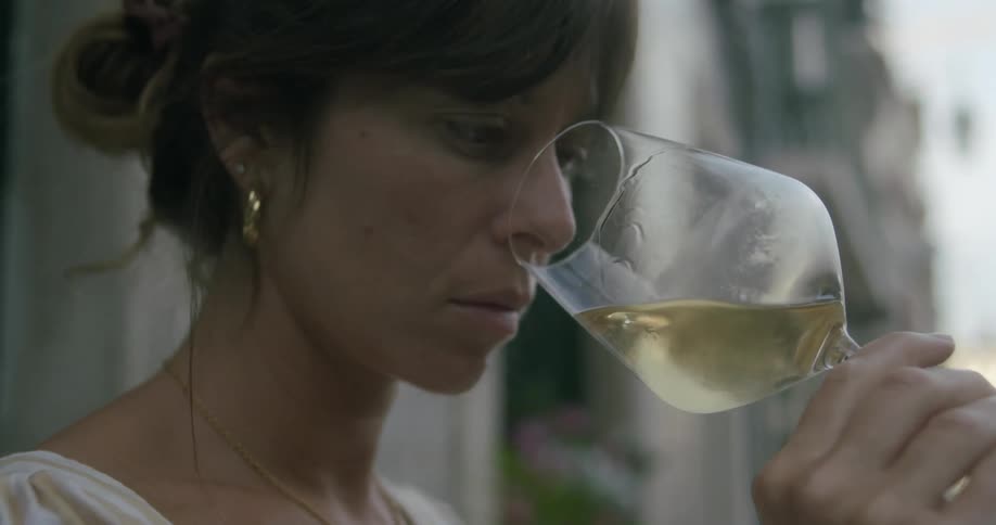 Woman smelling a glass of white wine