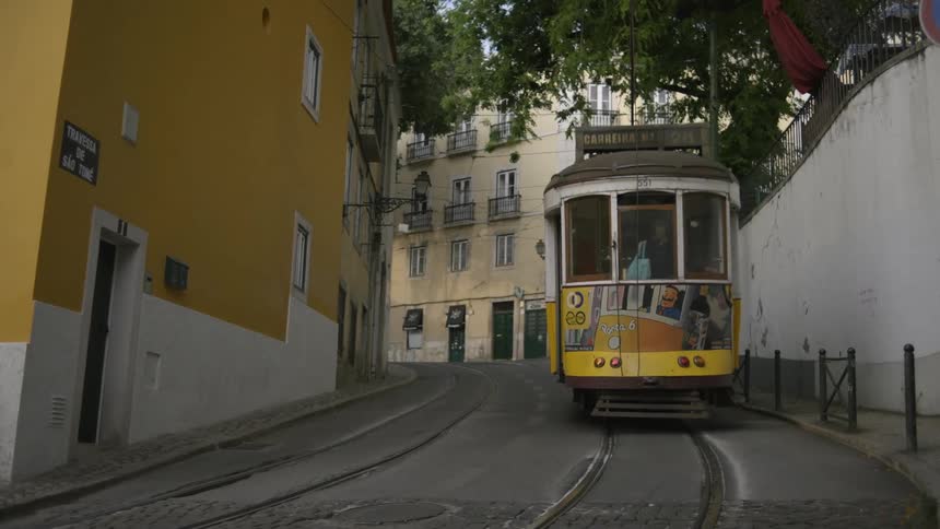 Cable car going up the street of a classic urban city