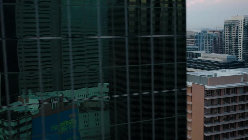 Aerial view of buildings in an urban city on a partly cloudy day