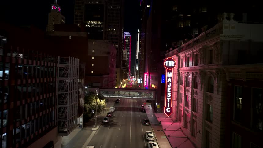 A street in an urban area with some street lights on at night